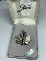 A MOTHER OF PEARL BROOCH IN A PRESENTATION BOX