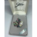 A MOTHER OF PEARL BROOCH IN A PRESENTATION BOX