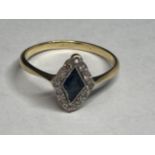 A 9 CARAT GOLD RING WITH A DIAMOND SHAPED SAPPHIRE SURROUNDED BY DIAMONDS SIZE J/K