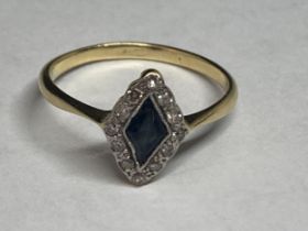 A 9 CARAT GOLD RING WITH A DIAMOND SHAPED SAPPHIRE SURROUNDED BY DIAMONDS SIZE J/K