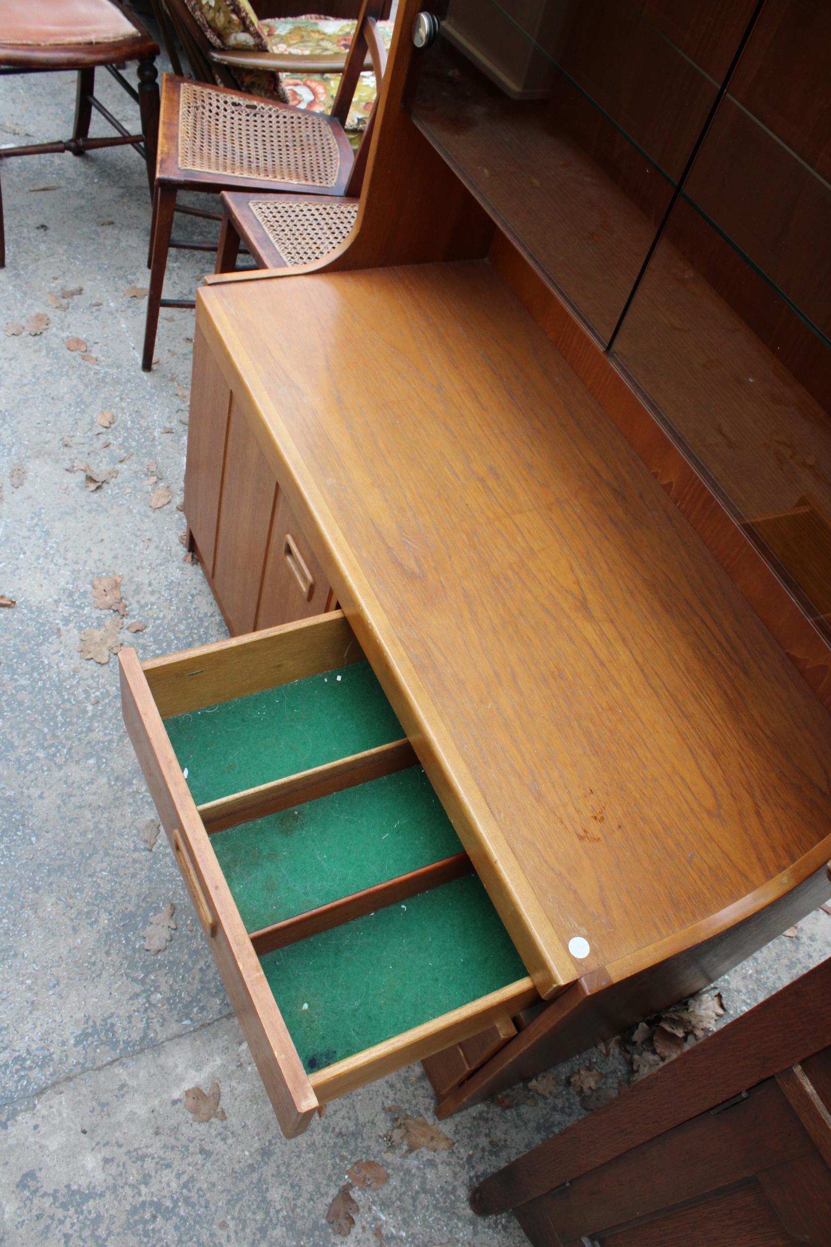 A RETRO TEAK UNIT WITH SMOKED GLASS DOORS, CUPBOARD AND DRAWERS TO BASE. 39.5" WIDE - Image 3 of 3