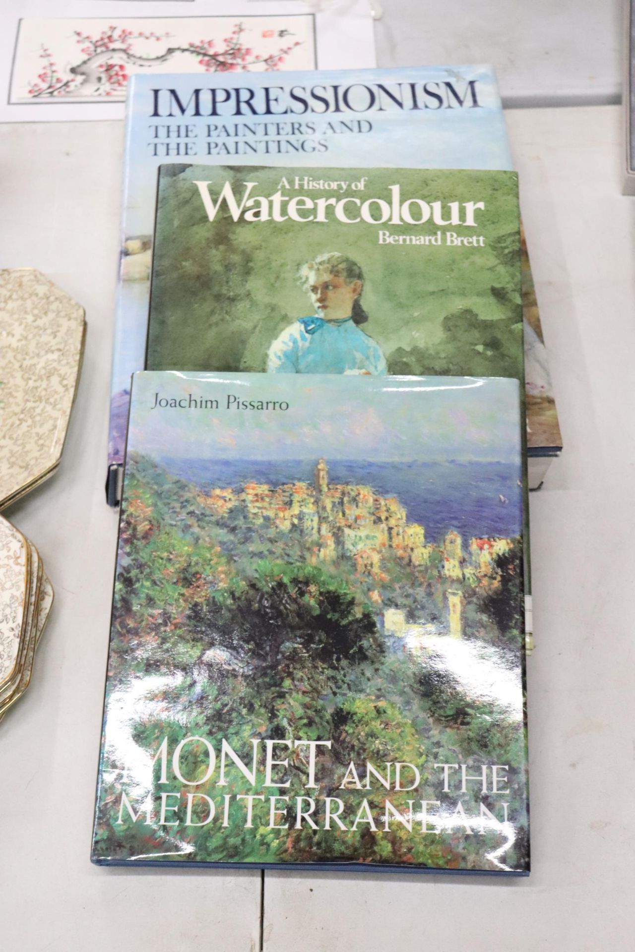 THREE HARDBACK ART THEMED BOOKS TO INCLUDE MONET AND THE MEDITERRANEAN, A HISTORY OF WATERCOLOUR AND