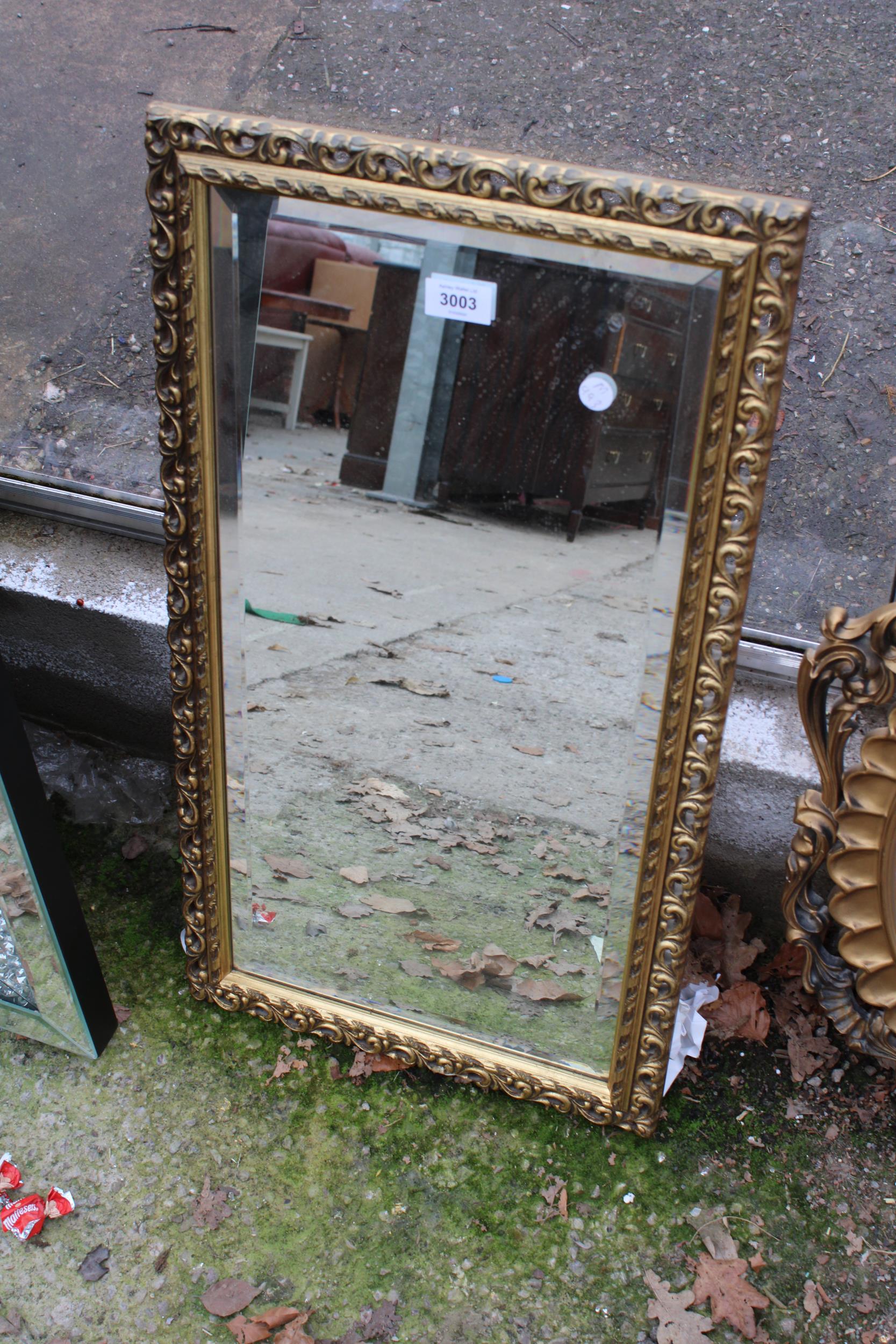 A GILT FRAMED BEVEL EDGE WALL MIRROR 27" X 15"