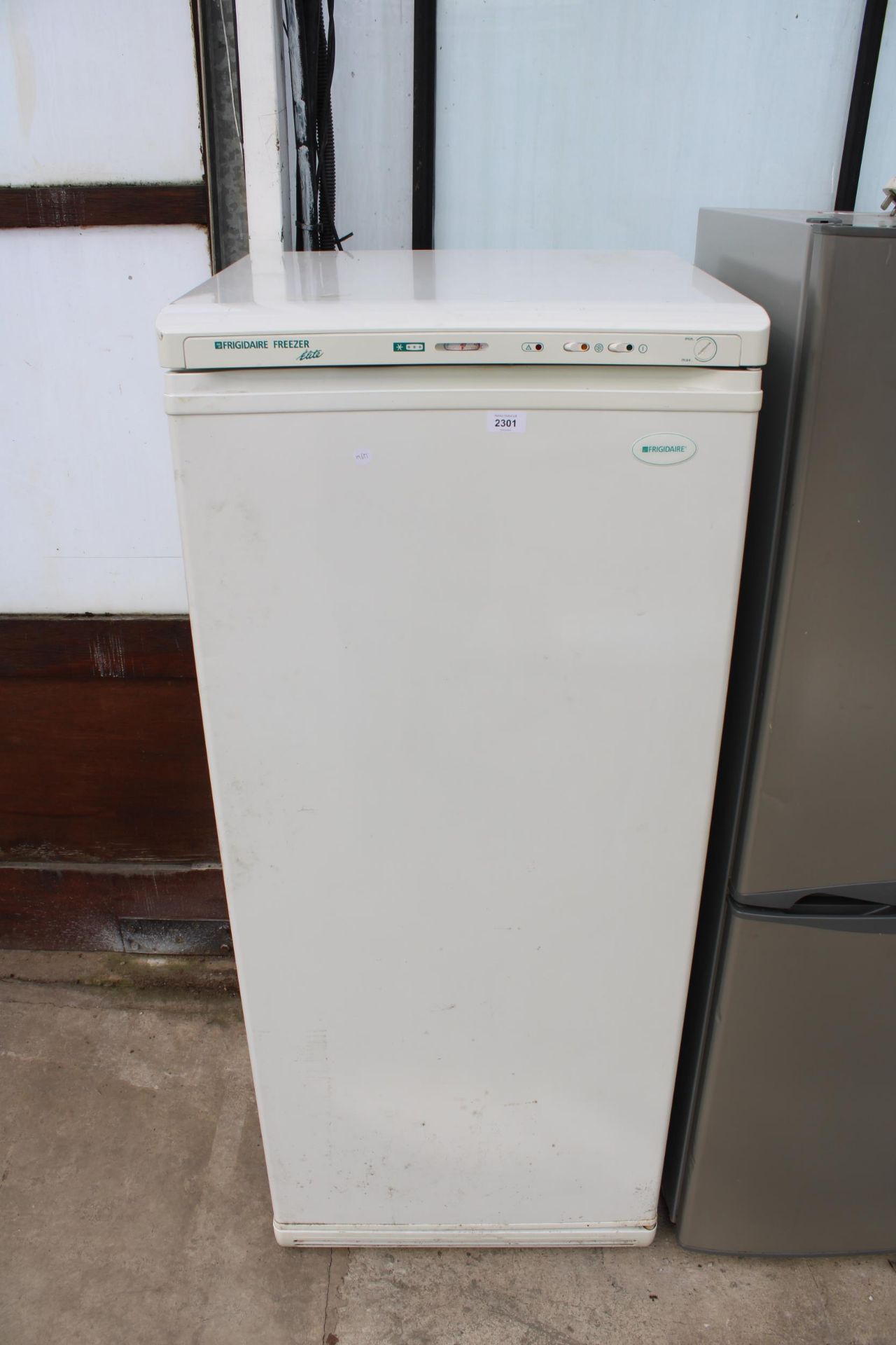 A WHITE FRIGIDAIRE UPRIGHT FREEZER