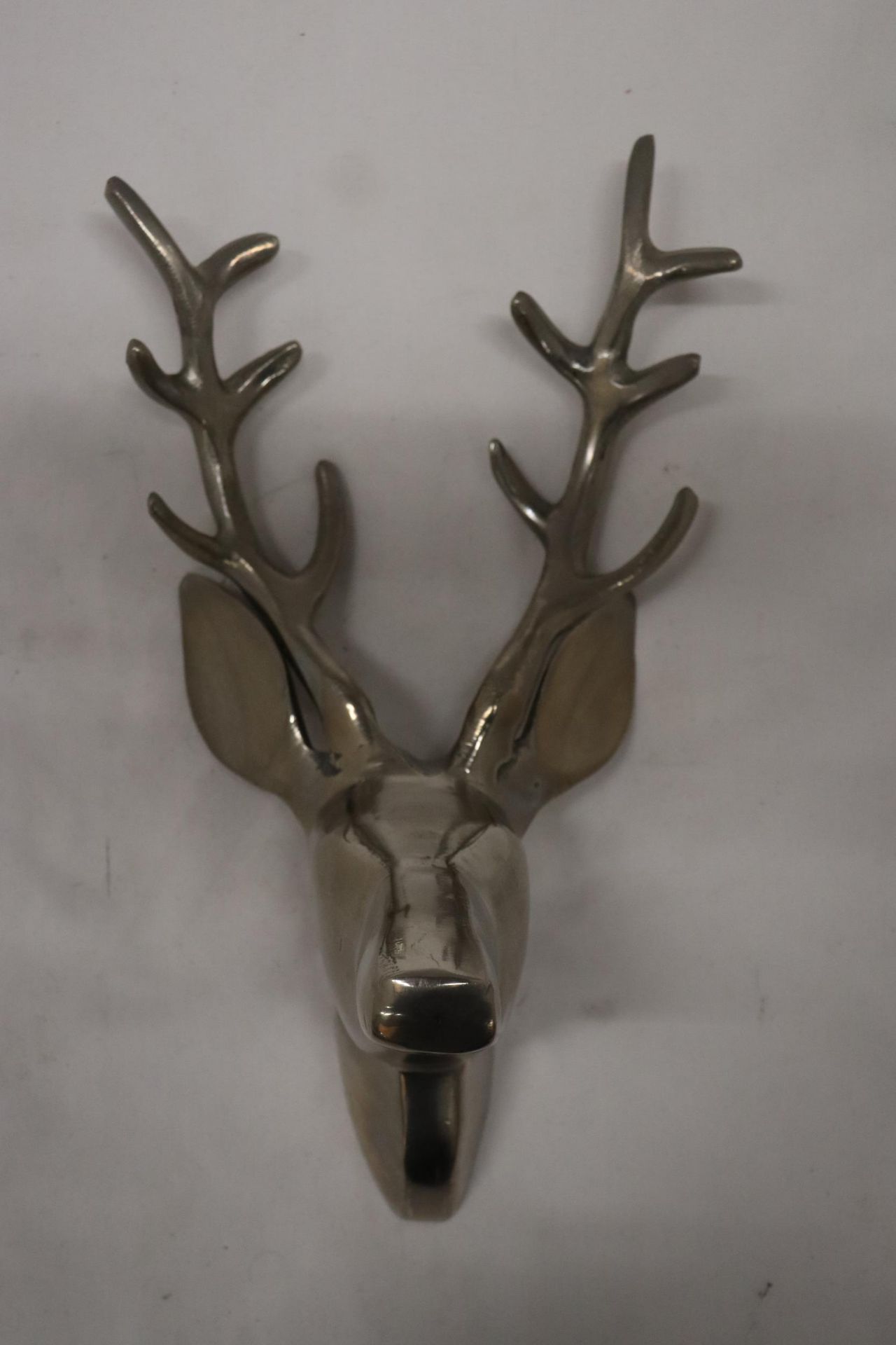 A STAINLESS STEEL DEER WALL HANGING