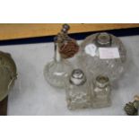 FOUR GLASS ITEMS WITH HALLMARKED SILVER TOPS