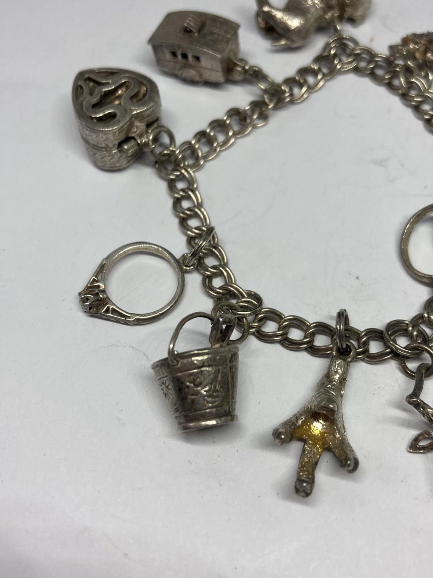 A SILVER CHARM BRACELET WITH TEN CHARMS - Image 3 of 4