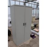 A METAL TWO DOOR WORKSHOP STORAGE CUPBOARD