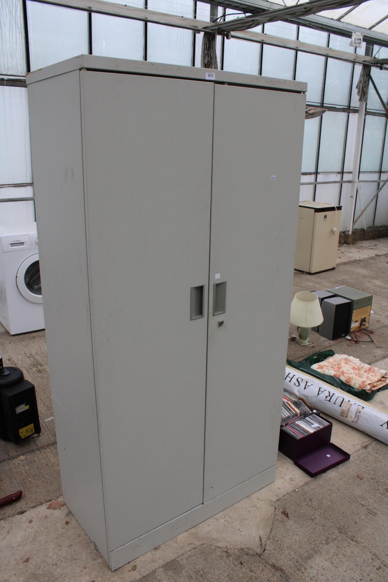 A METAL TWO DOOR WORKSHOP STORAGE CUPBOARD