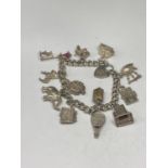 A SILVER CHARM BRACELET WITH TWELVE CHARMS