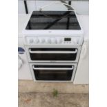 A BLACK AND WHITE HOTPOINT ELECTRIC OVEN AND HOB