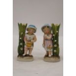 TWO VINTAGE GERMAN FAIRINGS TO INCLUDE A GIRL WITH JUG VASE AND A GIRL WITH BASKET VASE GOOD COLOURS