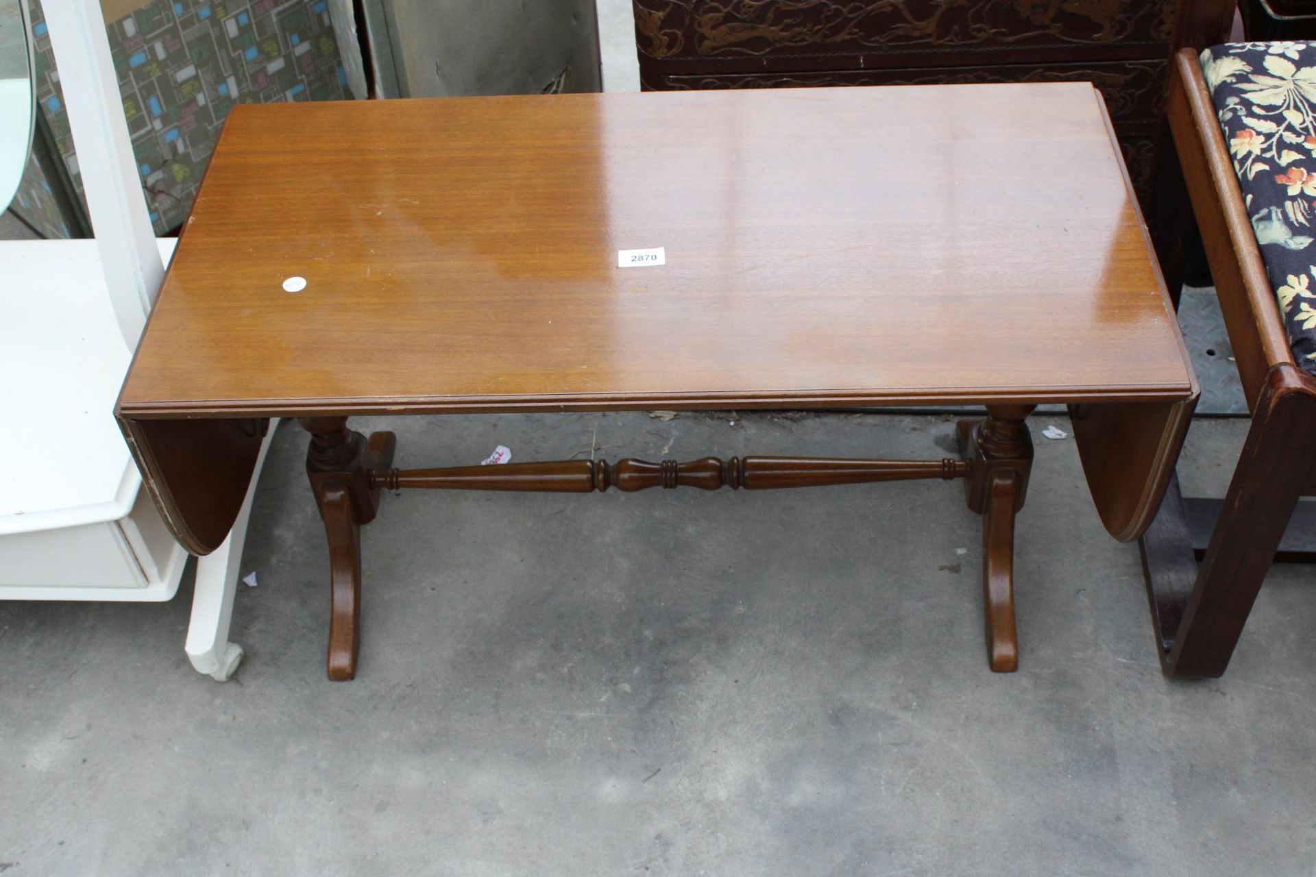 A MAHOGANY TWIN PEDESTAL DROP LEAF COFFEE TABLE