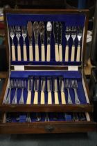 A VINTAGE CANTEEN OF CUTLERY IN A MAHOGANY CASE WITH BOTTOM DRAWER