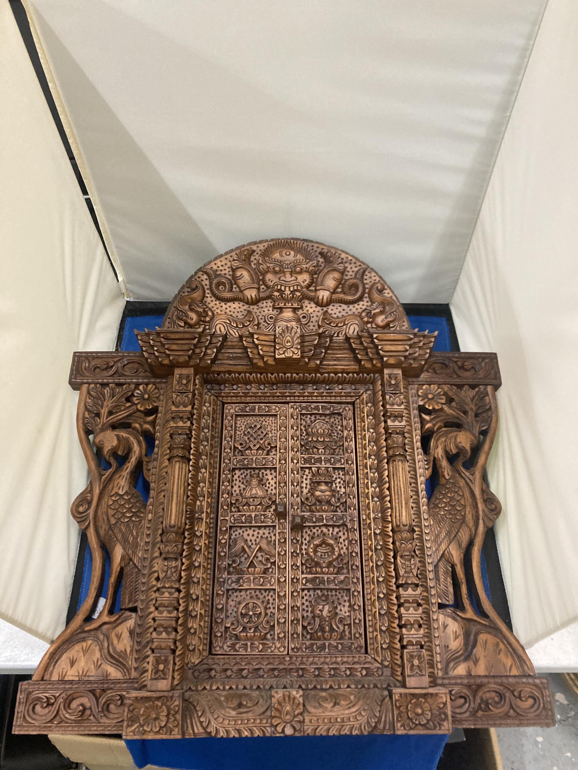 A HEAVILY CARVED ASTAMANGAL DOOR FRAME WALL HANGING