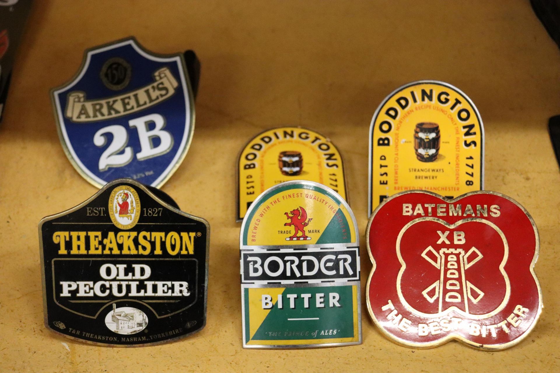SIX METAL BAR PUMP BREWERY MOUNTS TO INCLUDE THEAKSTON AND BODDINGTONS