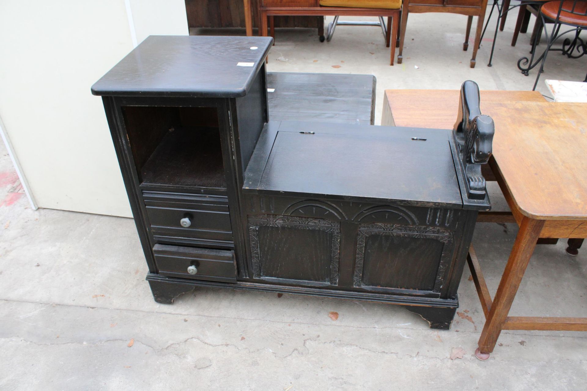 AN OAK TELEPHONE TABLE/SEAT ENCLOSING TWO DRAWERS AND A LIFT UP SEAT