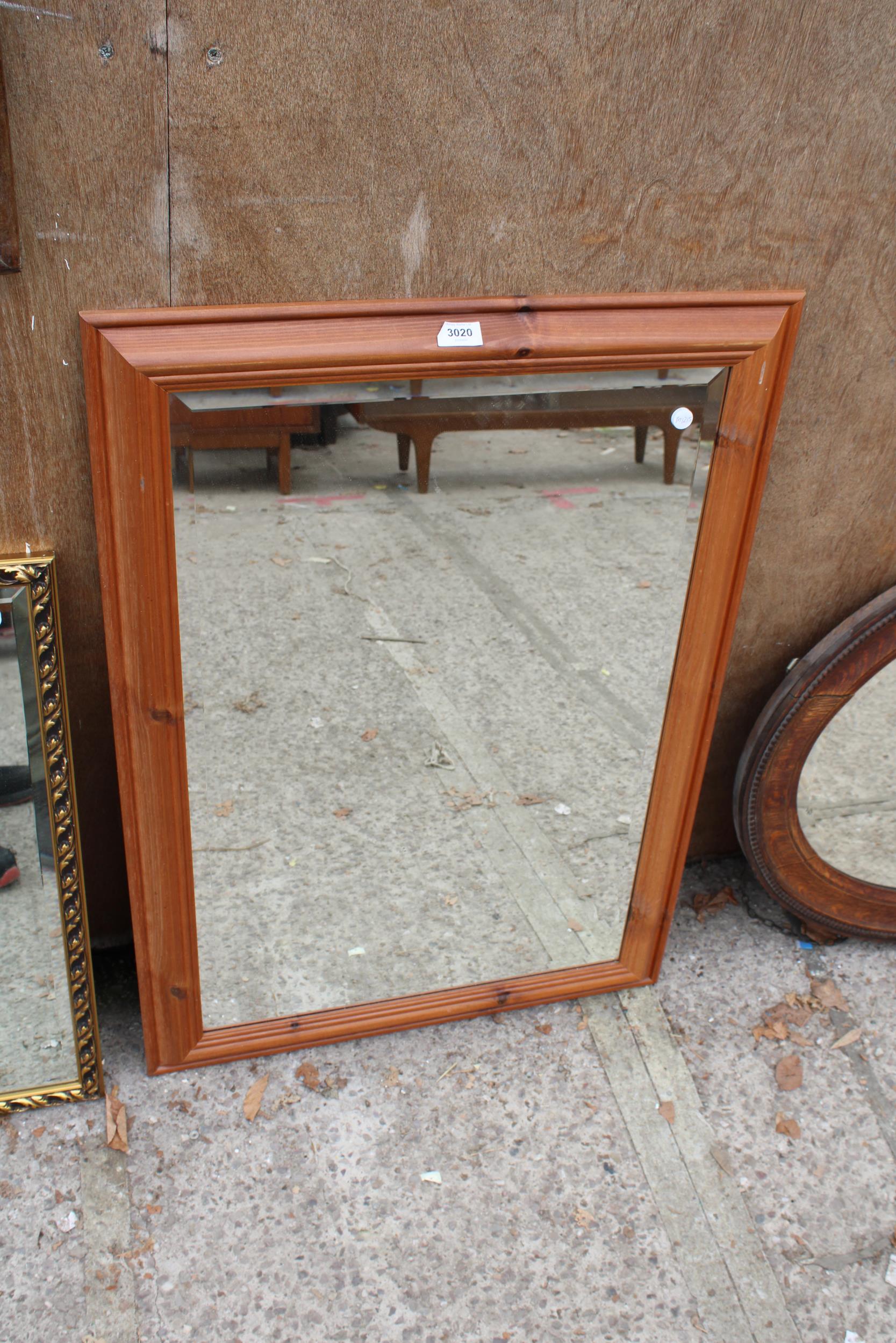 A PINE FRAMED BEVEL EDGE WALL MIRROR, 34" X 25"