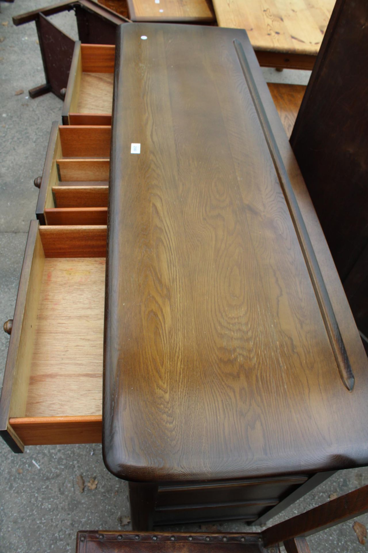 A REPRODUCTION DRESSER BASE ENCLOSING THREE DRAWERS AND THREE CUPBOARDS, 60" WIDE - Image 3 of 3