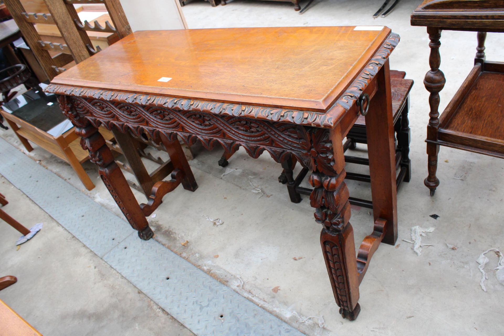 A VICTORIAN GOTHIC OAK HEAVILY CARVED SIDE TABLE, 41" WIDE