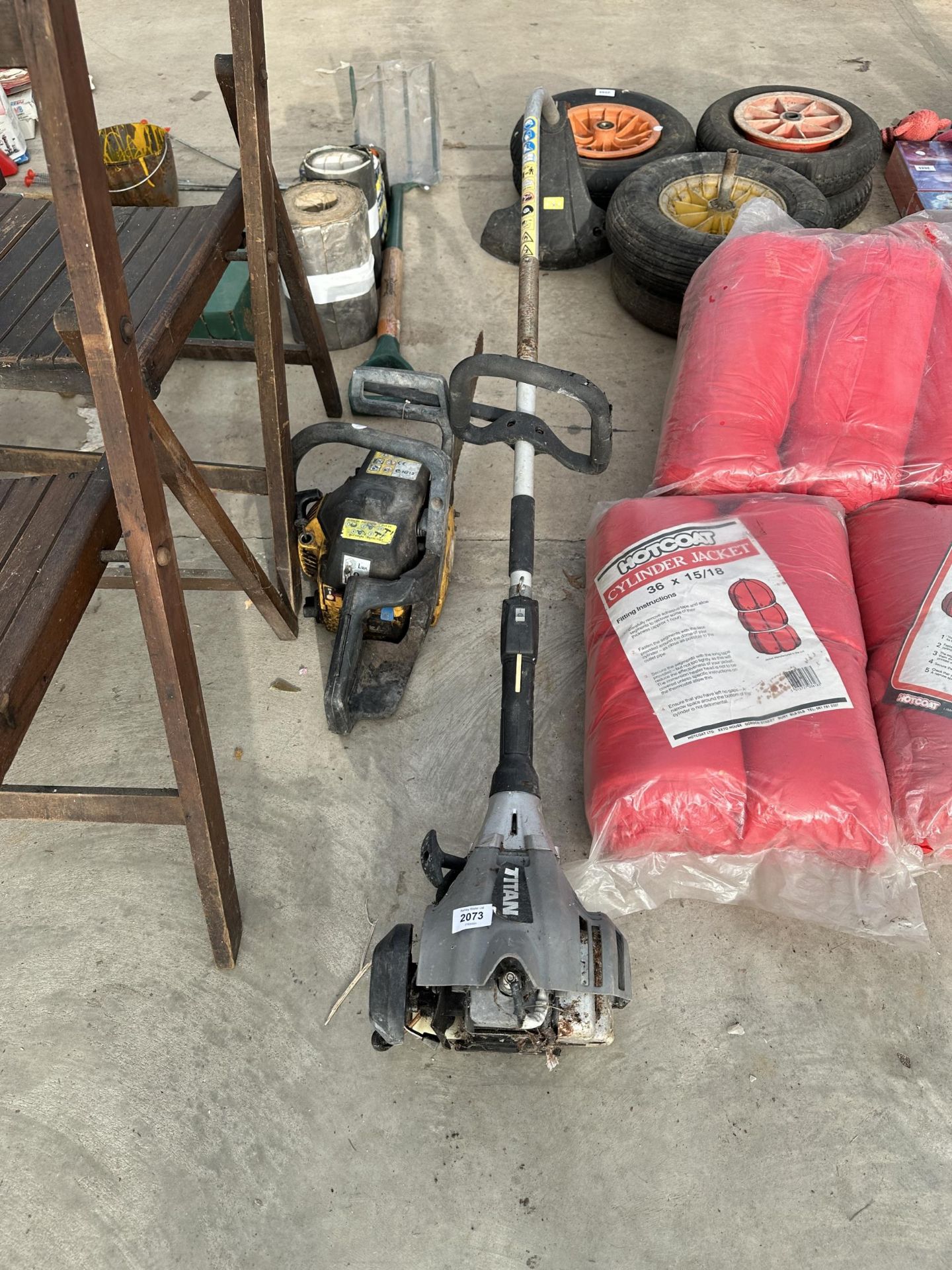 A TITAN PETROL GRASS STRIMMER AND A PETROL CHAINSAW