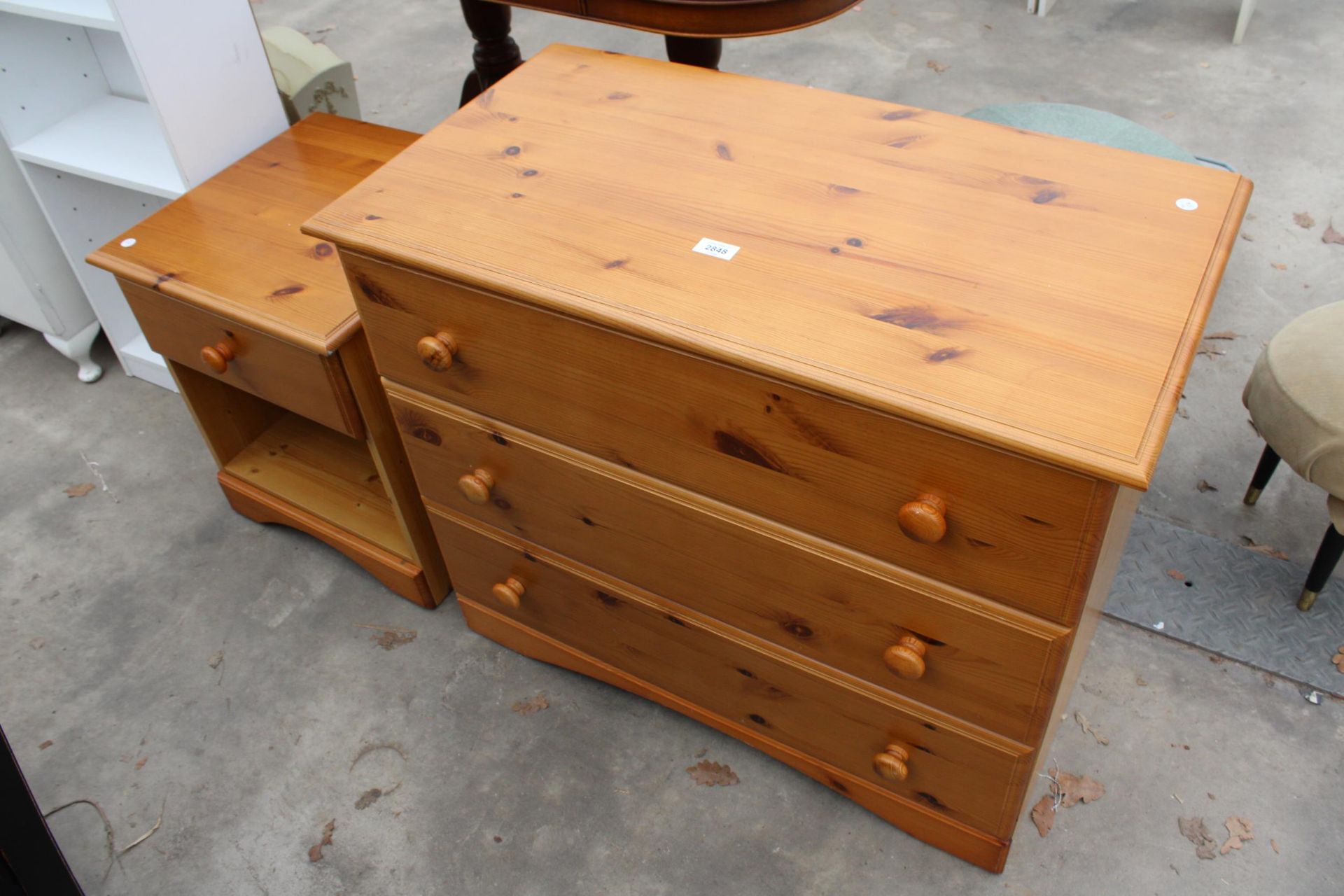 A PINE CHEST OF THREE DRAWERSAND MATCHING BEDSIDE CHEST