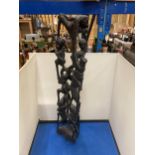 A HEAVILY CARVED AFRICAN EBONY FIGURE APPROX 56CM TALL