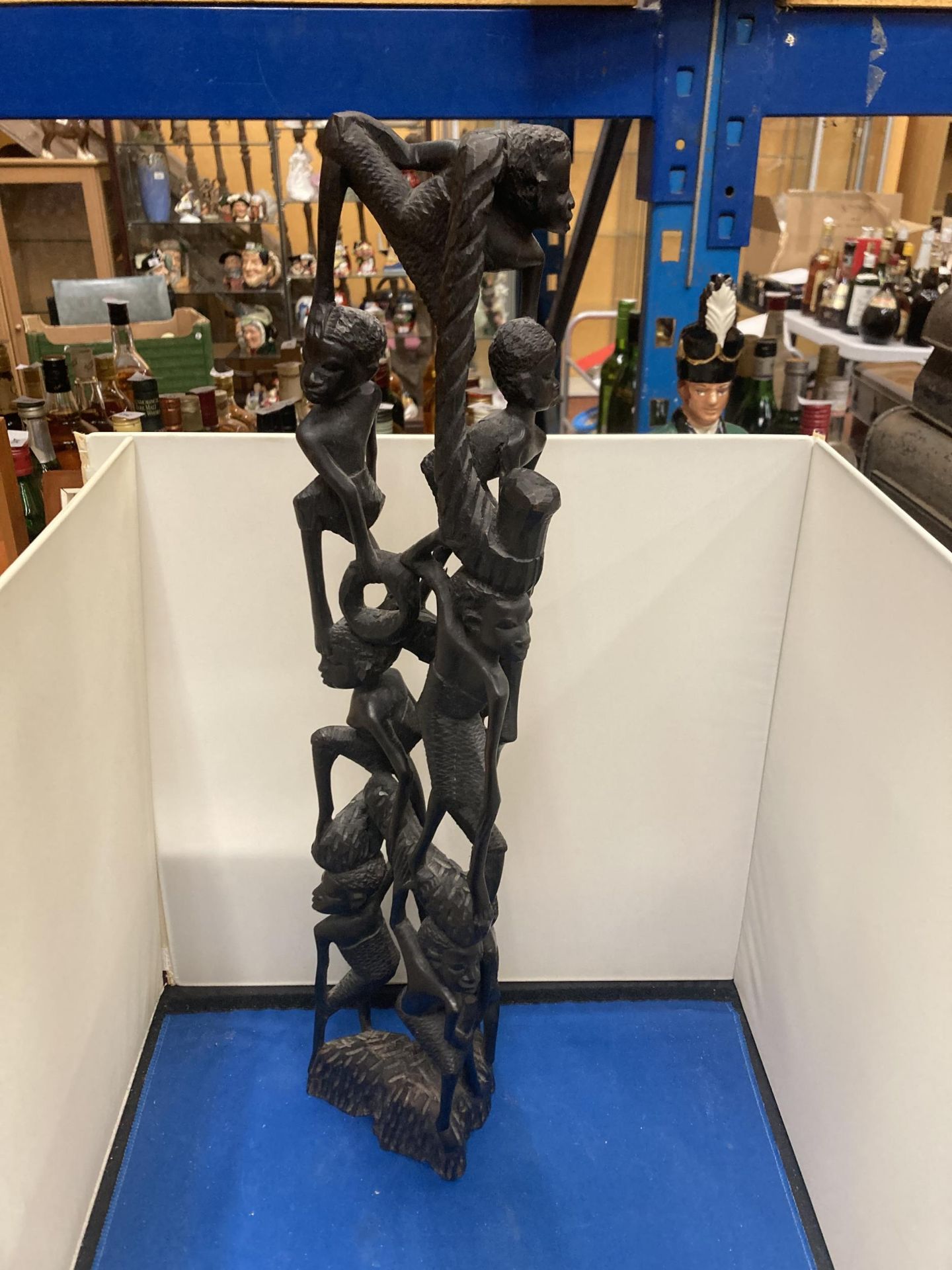 A HEAVILY CARVED AFRICAN EBONY FIGURE APPROX 56CM TALL