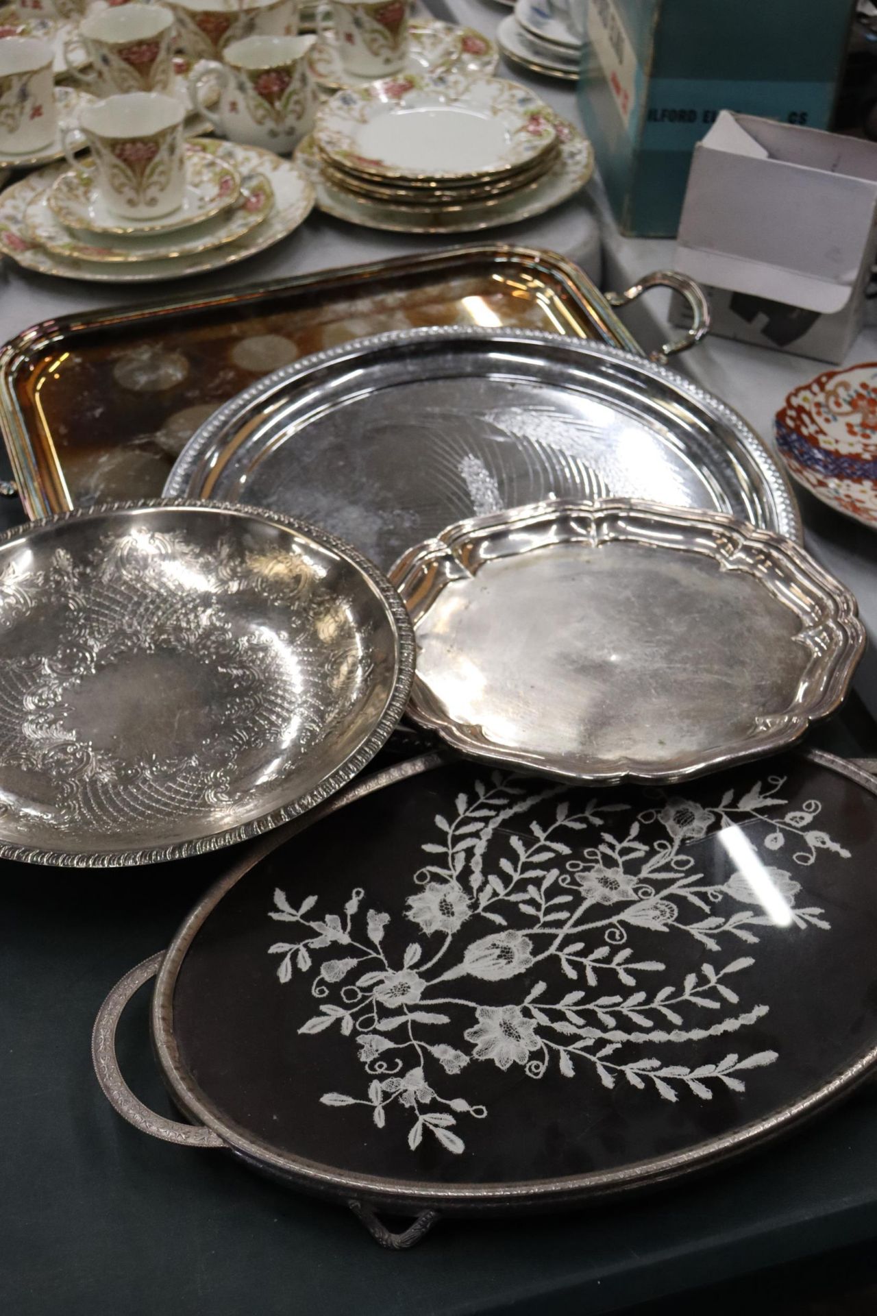 FIVE SILVER PLATE TRAYS ONE WITH AN EMBROIDERED INLAY