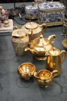 A GILT ROYAL WINTON TEAPOT, CREAM JUG AND SUGAR BOWL, ROYAL WORCESTER WATER JUG, PLUS A PATTERNED