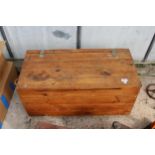 A PINE BLANKET/TOOL CHEST WITH WHEELS TO BASE