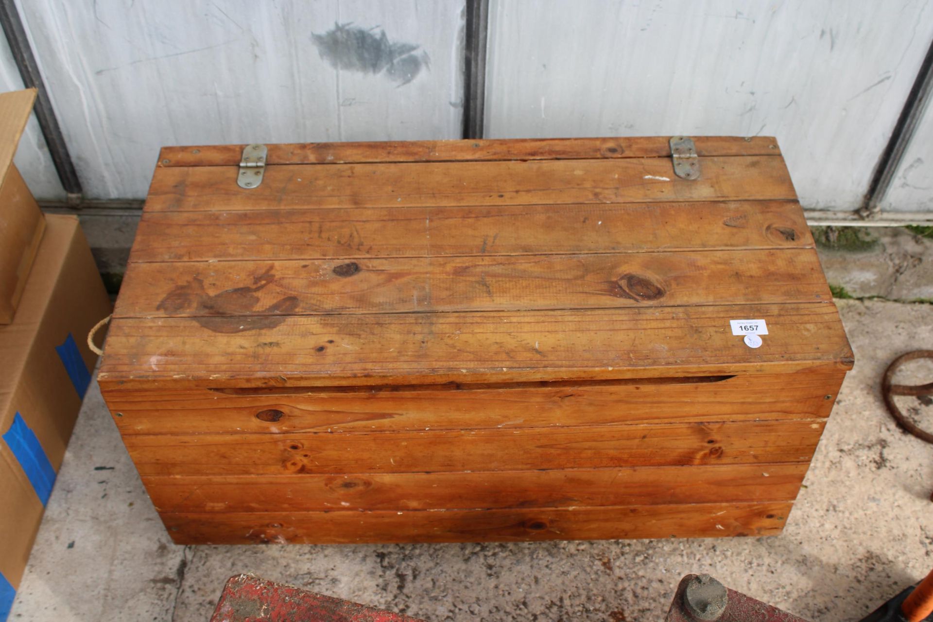 A PINE BLANKET/TOOL CHEST WITH WHEELS TO BASE