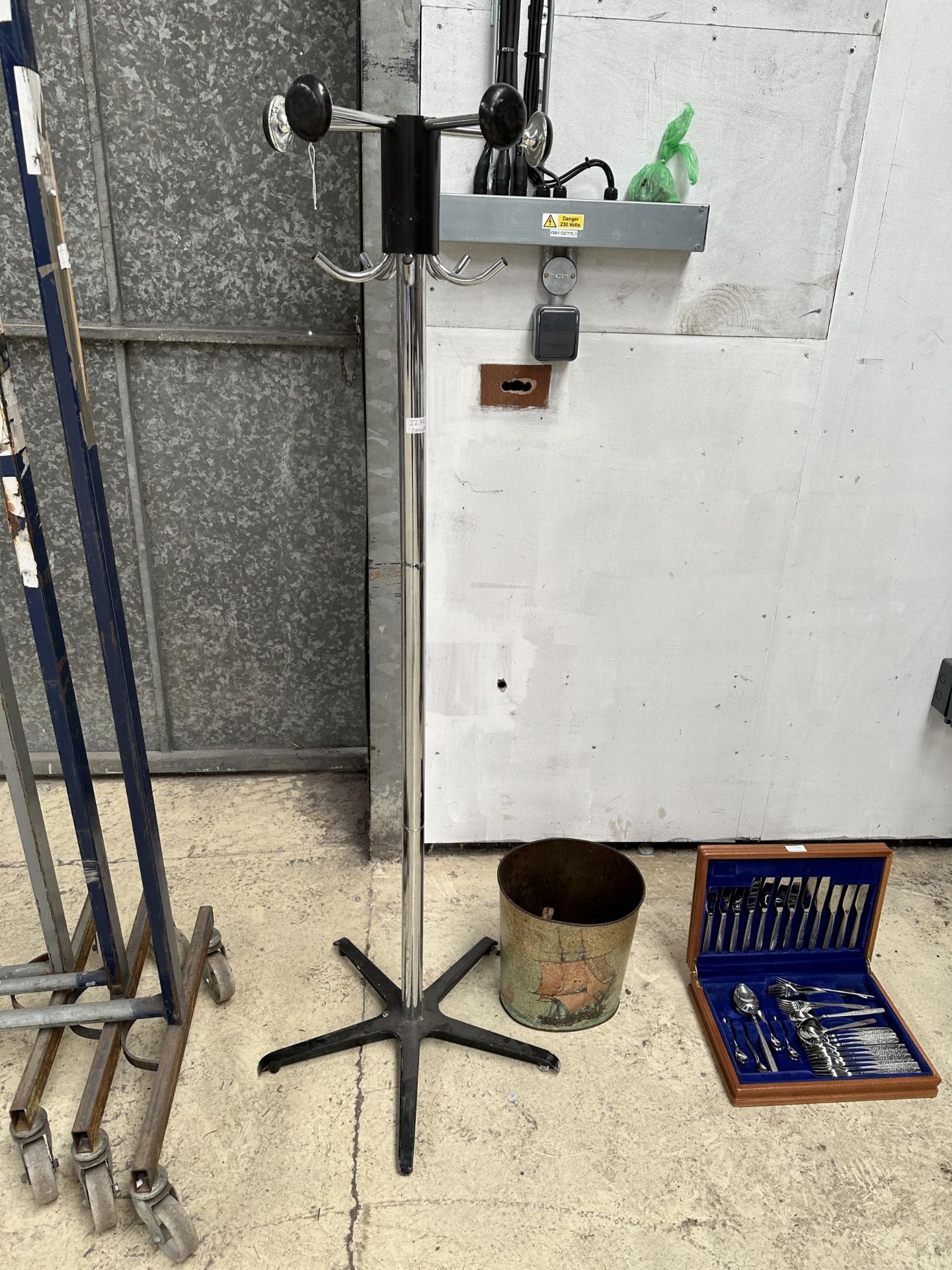 A CHROME COAT STAND AND A DECORATIVE PAPER BIN