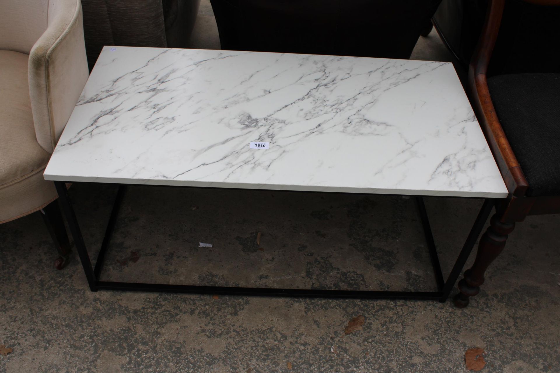 A MARBLE EFFECT COFFEE TABLE ON A METALWORK FRAME 36" X 19"