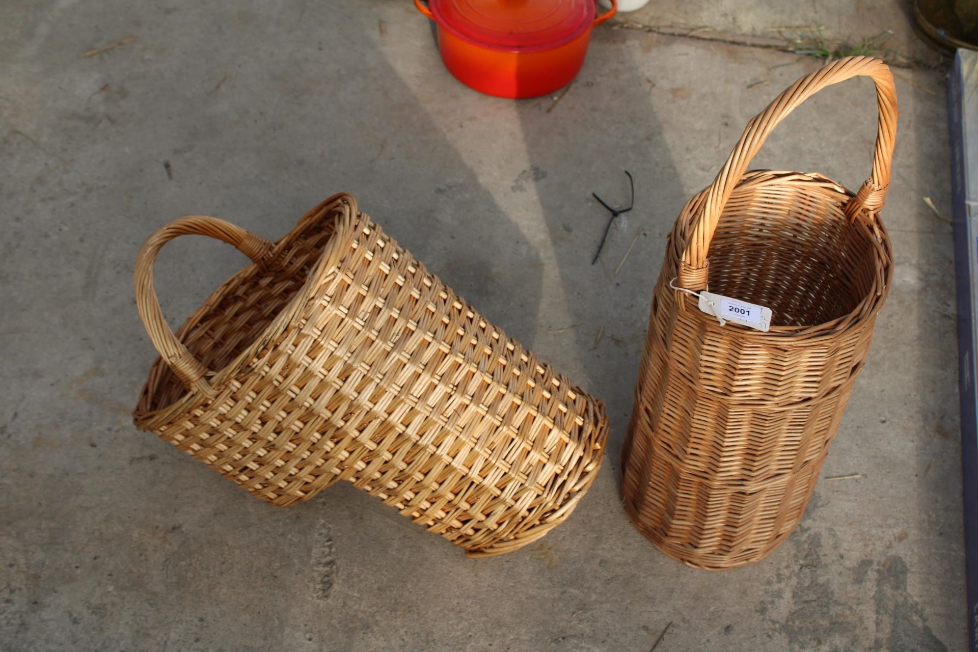 A TALL WICKER BASKET AND A STEPPED WICKER BASKET