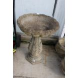 A CONCRETE BIRDBATH WITH PEDESTAL BASE