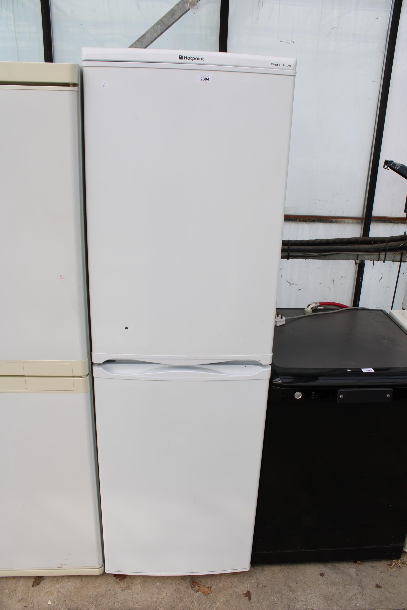 A TALL WHITE HOTPOINT UPRIGHT FRIDGE FREEZER