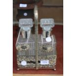 A VINTAGE SILVER PLATED TANTALUS WITH TWO CUT GLASS DECANTORS AND SILVER PLATED LABELS