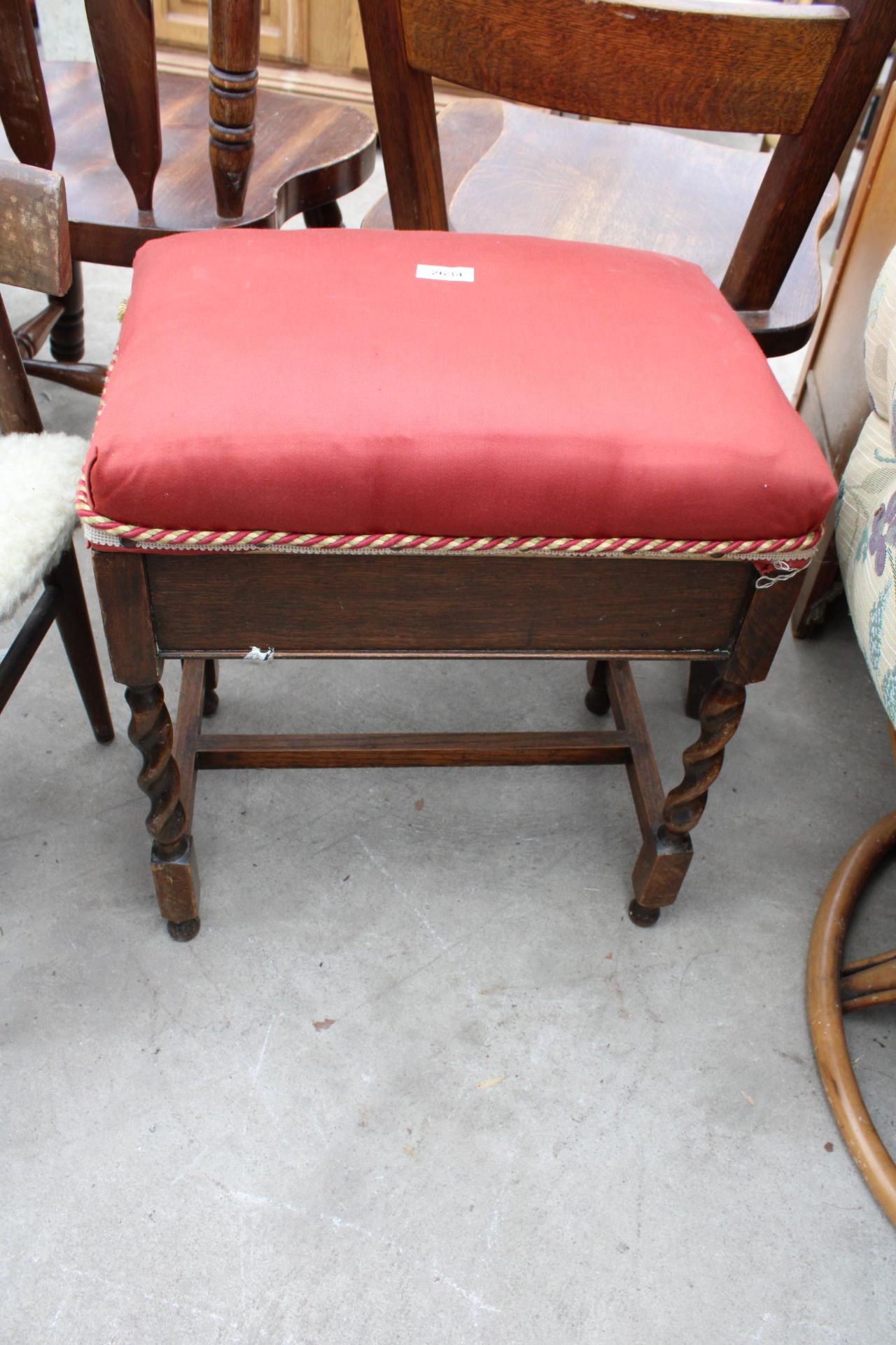 AN OAK BARLEY TWIST PIANO STOOLWITH LIFT UP LID