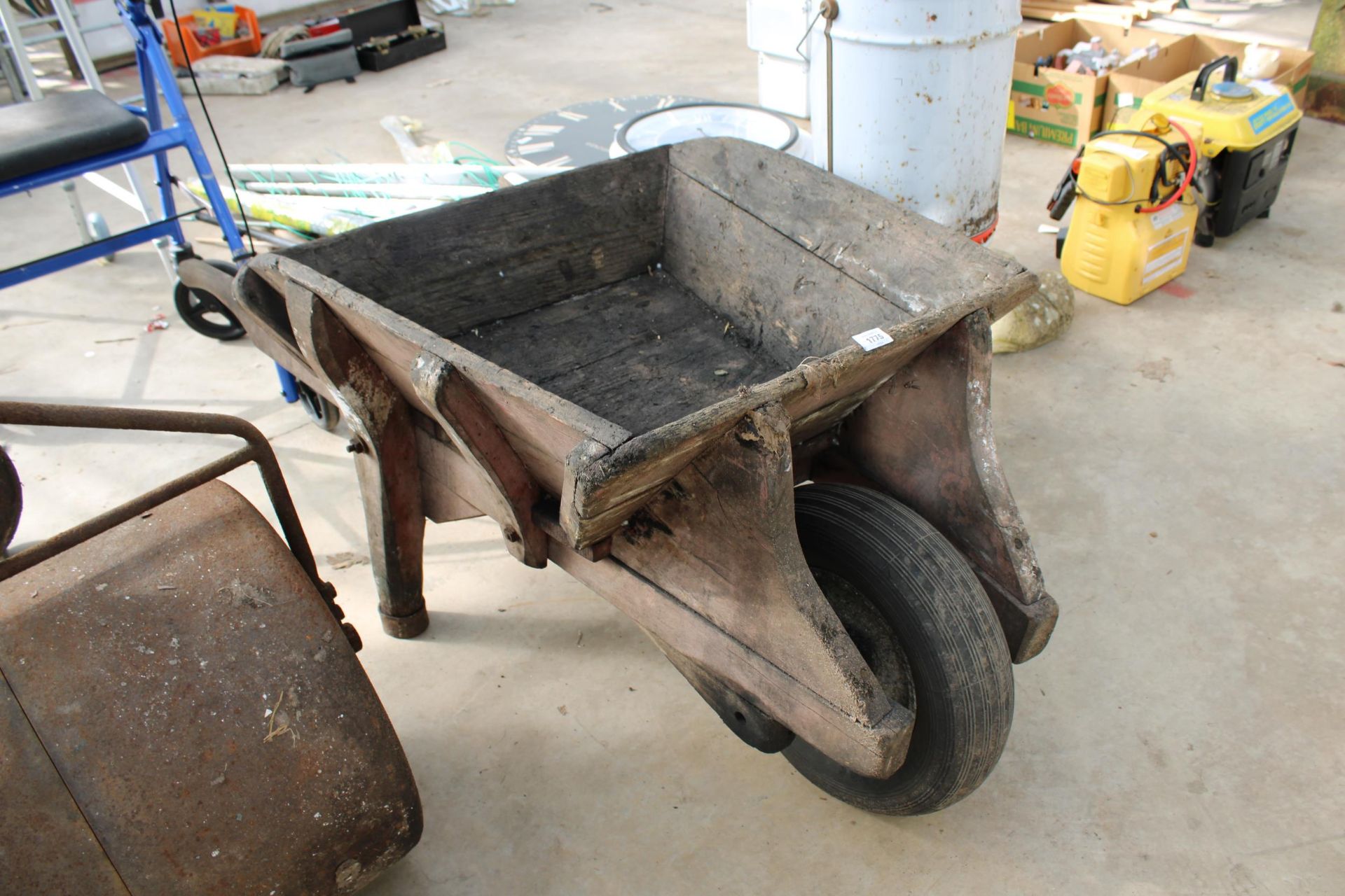 A WOODENGARDEN WHEEL BARROW PLANTER WITH RUBBER TYRE