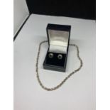 A PAIR OF SILVER EARRINGS AND A SILVER NECKLACE IN A PRESENTATION BOX