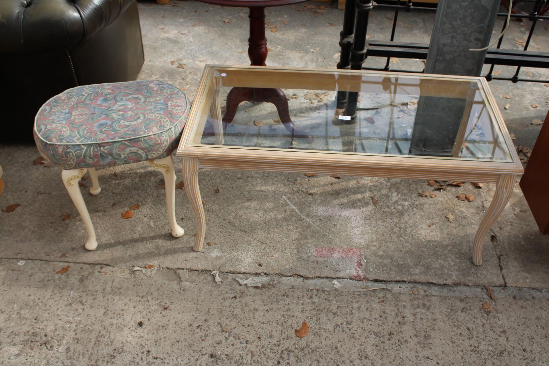 A LIMED COFFEE TABLE WITH GLASS TOP AND A STOOL ON CABRIOLE LEGS