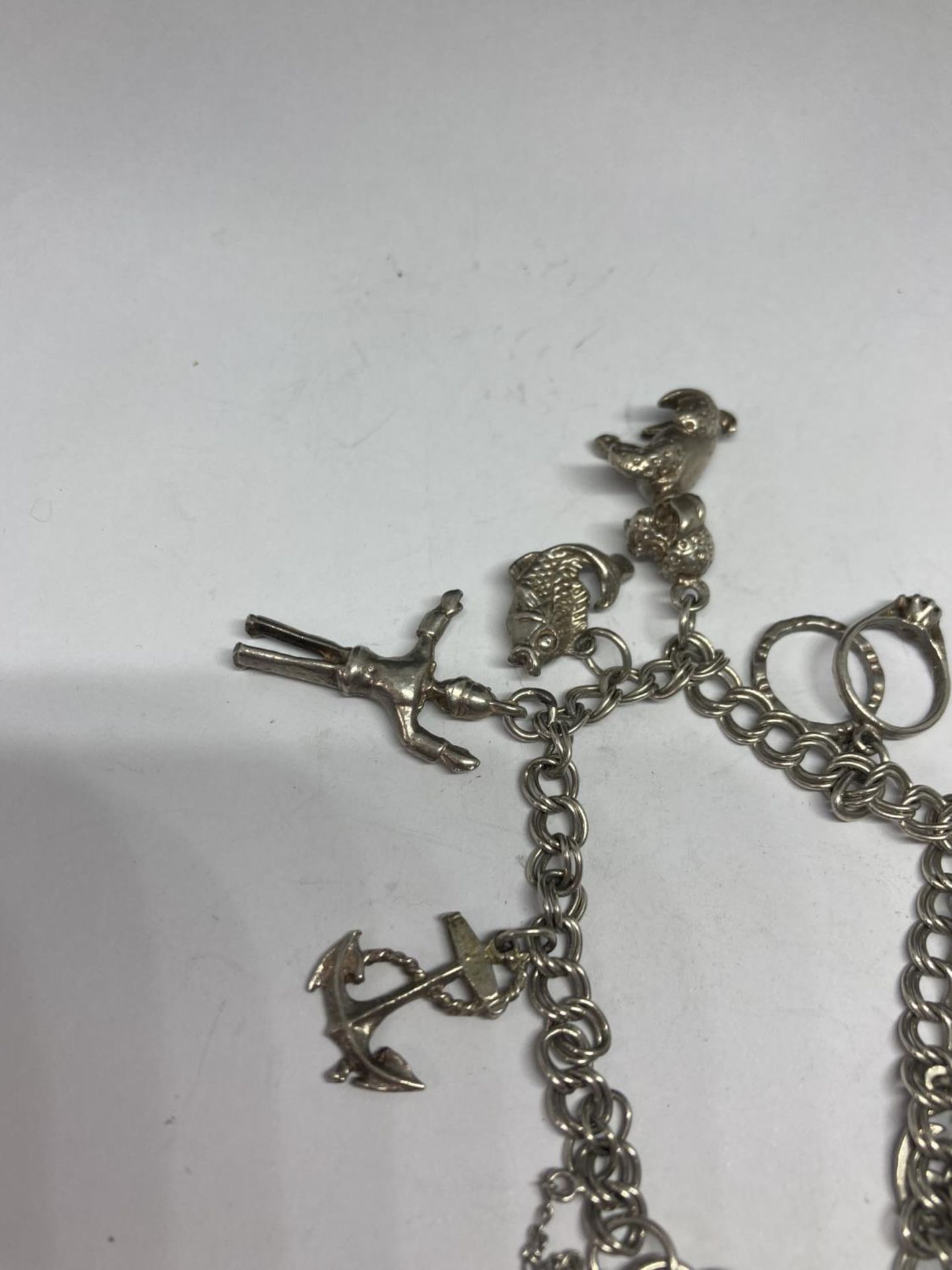 A SILVER CHARM BRACELET WITH TEN CHARMS AND A HEART PADLOCK - Image 2 of 4