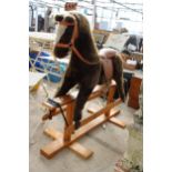 A WOODEN FRAMED PLUSH CHILDS ROCKING HORSE