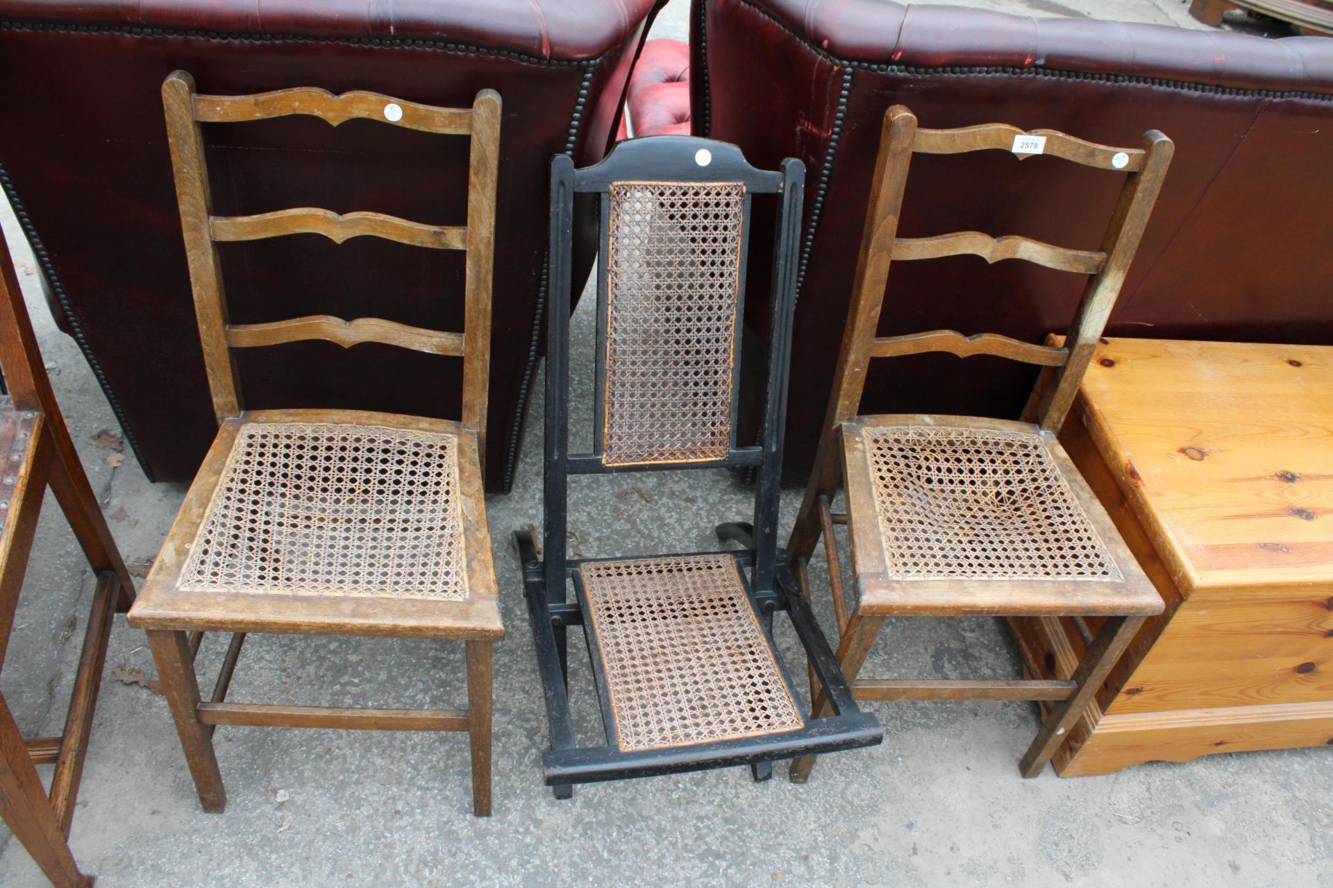 A PAIR OF EDWARDIAN BEDROOM CHAIRS AND EBONISED CAMPAIGN STYLE FOLDING CHAIR WITH CANE BACK AND SEAT