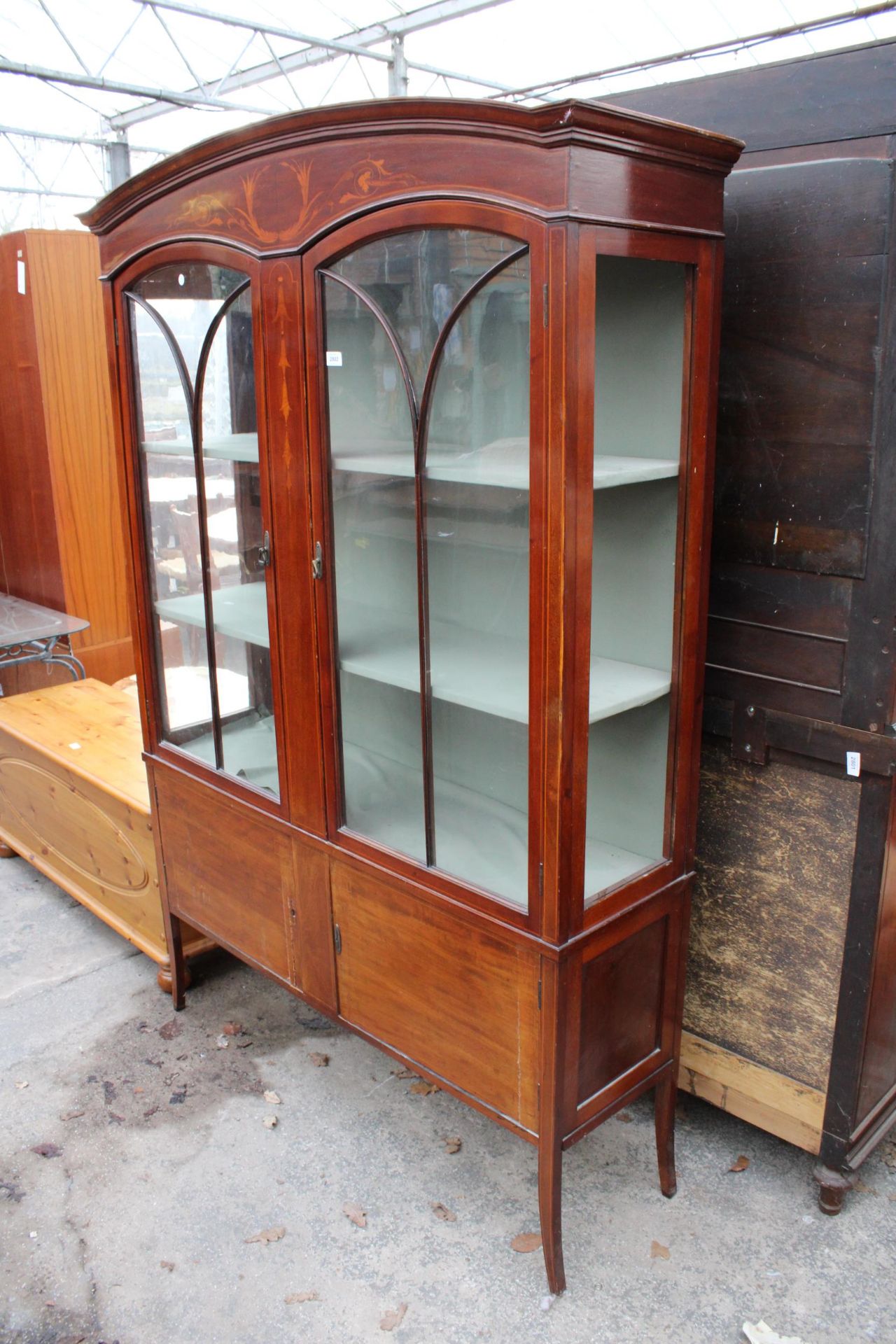 AN EDWARDIAN MAHOGANY AND INLAID TWO DOOR DISPLAY CABINET 51" WIDE