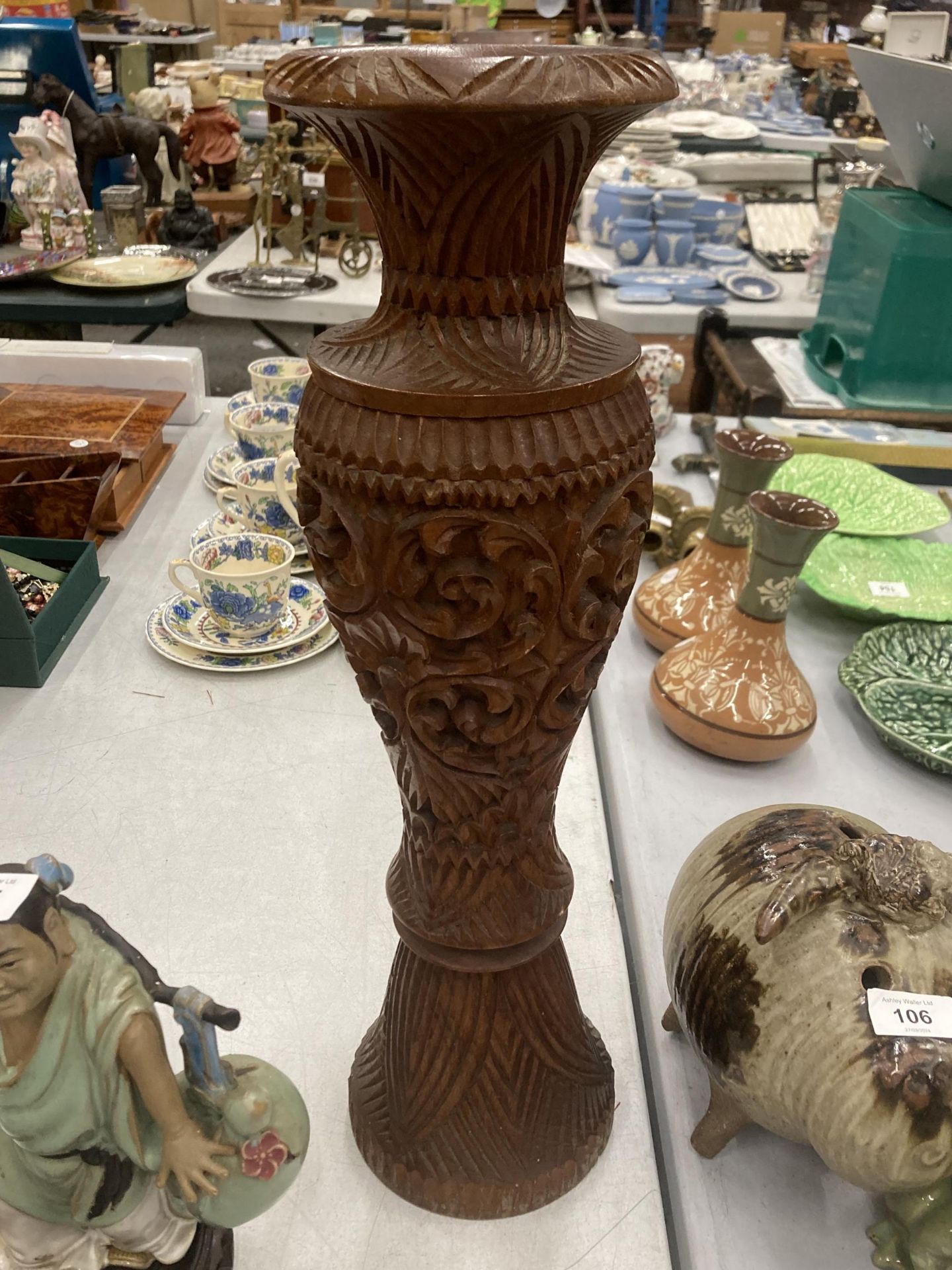 A LARGE HEAVILY CARVED WOODEN VASE, HEIGHT 50CM