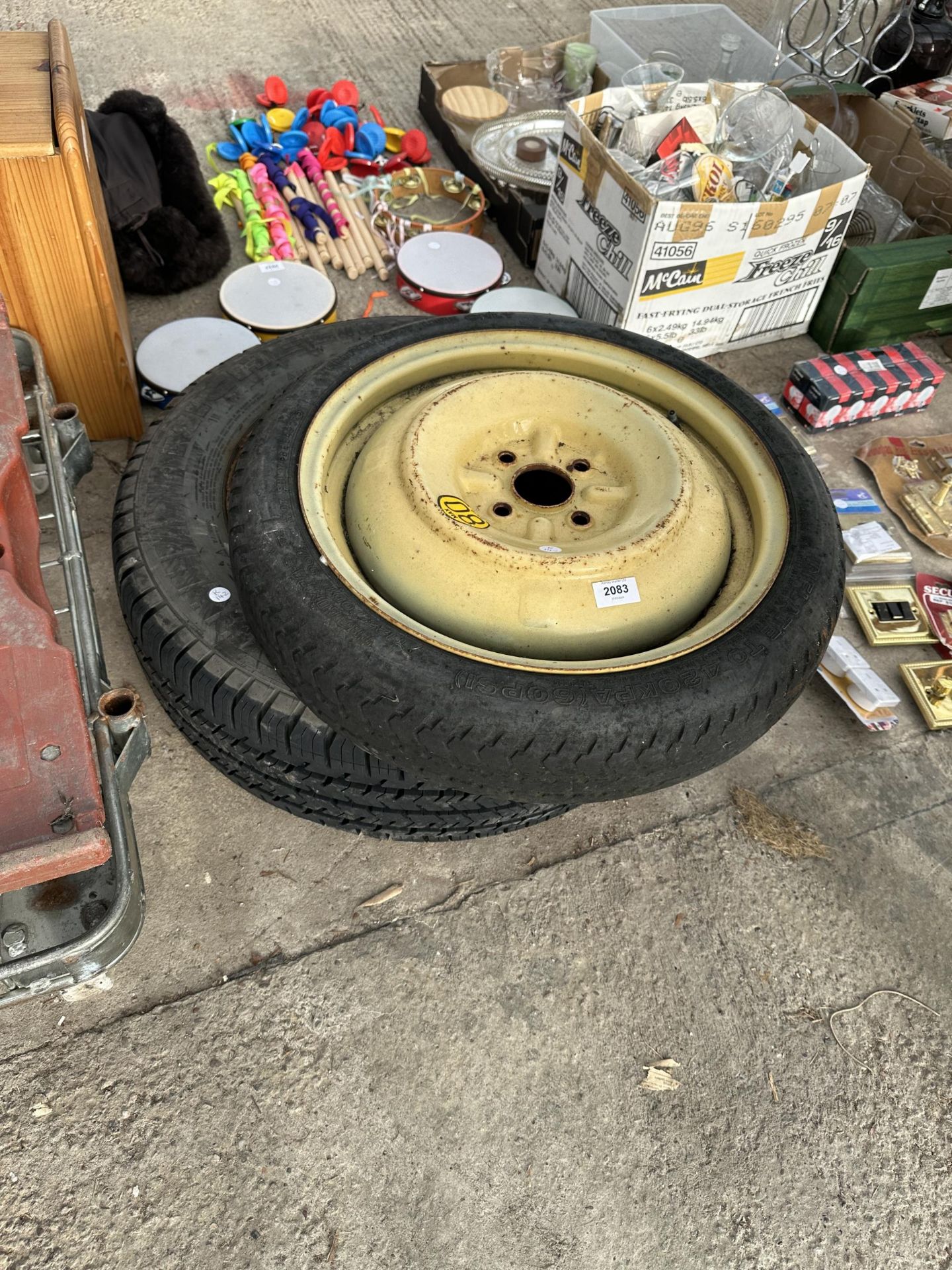 A VINTAGE WHEEL AND TYRE AND A FURTHER WHEEL AND TYRE