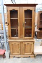 A BEECH TWO DOOR BOOKCASE ON BASE 41" WIDE