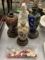 THREE ORIENTAL VASES ON WOODEN STANDS TO INCLUDE CLOISONNE, A SEATED FIGURE, ETC